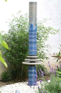 Gartenbrunnen Design aus winterfester Keramik mit gerillter Säule und kaskadenförmiges Abtropfen über Teller, dezente Akustik