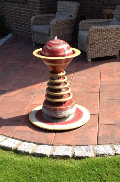 Gartenbrunnen Design aus winterfester Keramik mit gerillter Halbkugel und kaskadenförmiges Abtropfen über Teller, dezente Akustik